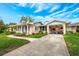 Charming single-story home with a well-manicured lawn and covered entrance at 936 N Baker St, Mount Dora, FL 32757