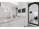 Modern bathroom with double vanity, white cabinetry, framed mirror, and glass shower at 10246 Hadley St, Orlando, FL 32829