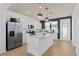 Bright kitchen with stainless steel appliances, quartz countertops, and a center island at 10246 Hadley St, Orlando, FL 32829