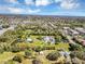 Aerial view of the property featuring mature landscaping, large yard, a pond and detached structures at 11207 Roberson Rd, Winter Garden, FL 34787