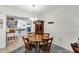 Cozy dining area with wood table and chairs, decorative chandelier, and view of the spacious living room at 11207 Roberson Rd, Winter Garden, FL 34787