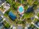 Community aerial view of a pool, tennis court, landscaping, and surrounding homes at 1154 Seneca Trl, St Cloud, FL 34772