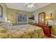 Relaxing bedroom featuring tropical themed bedspread, neutral walls, wood floors, and window with natural light at 1154 Seneca Trl, St Cloud, FL 34772