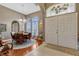 Inviting foyer with tile and wood floors leads to an elegant dining area with large windows and natural light at 1154 Seneca Trl, St Cloud, FL 34772