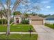 Beautiful single-story home with manicured lawn, mature trees and a two-car garage, offering great curb appeal at 1154 Seneca Trl, St Cloud, FL 34772