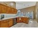 Bright kitchen with wood cabinets, tile backsplash, white countertops and stainless steel appliances at 1154 Seneca Trl, St Cloud, FL 34772