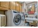 Well-equipped laundry room featuring front loading washer and dryer and cabinet storage at 1154 Seneca Trl, St Cloud, FL 34772