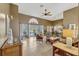 Bright living room with tile flooring, ceiling fan, arched doorways and sliding glass doors to a screened patio at 1154 Seneca Trl, St Cloud, FL 34772