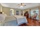 Well lit main bedroom with wood floors, tray ceiling, ensuite bathroom, and sliding doors to the lanai at 1154 Seneca Trl, St Cloud, FL 34772