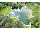 Overhead view of a beautiful natural spring pool surrounded by lush greenery and walking paths at 116 Crown Oaks Way # 116, Longwood, FL 32779