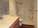 Bathroom featuring a shower with marble tiling, wooden cabinets and a white sink at 116 Crown Oaks Way # 116, Longwood, FL 32779