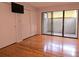 Bedroom featuring hardwood floors, sliding glass door to patio, and closet at 116 Crown Oaks Way # 116, Longwood, FL 32779