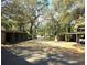 Driveway with covered parking and mature shade trees at 116 Crown Oaks Way # 116, Longwood, FL 32779