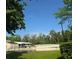 Equestrian arena with a horse visible near a white fence amid lush greenery and blue skies at 116 Crown Oaks Way # 116, Longwood, FL 32779