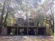 Exterior view of townhome with covered parking featuring mature trees at 116 Crown Oaks Way # 116, Longwood, FL 32779