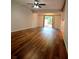 Spacious living room featuring wood flooring, a ceiling fan, and sliding glass doors at 116 Crown Oaks Way # 116, Longwood, FL 32779