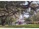 Picturesque view of a playground with mature trees covered in Spanish moss in a lush, green park at 116 Crown Oaks Way # 116, Longwood, FL 32779