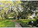 Scenic park featuring mature trees with Spanish moss, a playground, and a winding brick pathway at 116 Crown Oaks Way # 116, Longwood, FL 32779