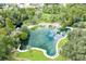 Birds eye view of a large, natural swimming pool surrounded by trees at 116 Crown Oaks Way # 116, Longwood, FL 32779