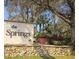 Entrance sign for The Springs community surrounded by mature landscaping at 116 Crown Oaks Way # 116, Longwood, FL 32779