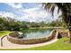 Picturesque water feature with stone accents, clear water, surrounded by mature trees and green lawns at 116 Crown Oaks Way # 116, Longwood, FL 32779