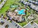 Aerial view of a community pool, tennis court, playground, parking, and landscaping at 12024 Sonnet Ave, Orlando, FL 32832