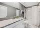 Well-lit bathroom featuring gray walls, granite counters and shower over bath at 12024 Sonnet Ave, Orlando, FL 32832