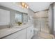 Bathroom with double sink vanity, stone countertops, large mirror, and walk-in glass shower at 12024 Sonnet Ave, Orlando, FL 32832