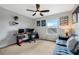 Neutral bedroom with natural light, ceiling fan, and desk with computer setup at 12024 Sonnet Ave, Orlando, FL 32832