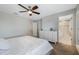 Neutral bedroom with ceiling fan, dresser, and ensuite bathroom, creating a relaxing retreat at 12024 Sonnet Ave, Orlando, FL 32832