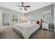 Bright bedroom with a ceiling fan, neutral walls, and plush carpet flooring at 12024 Sonnet Ave, Orlando, FL 32832