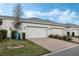 Three car garage with brick paver driveway and well maintained lawn, creating great curb appeal at 12024 Sonnet Ave, Orlando, FL 32832