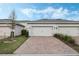 This home features a paved driveway leading to a two-car garage, providing ample parking space at 12024 Sonnet Ave, Orlando, FL 32832