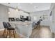 Modern kitchen featuring sleek countertops, white cabinetry, stainless steel appliances, and barstool seating at 12024 Sonnet Ave, Orlando, FL 32832