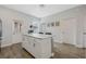 Kitchen island featuring white cabinetry, stainless steel handles, and a solid surface countertop at 12024 Sonnet Ave, Orlando, FL 32832