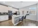 Modern kitchen features white cabinetry, stainless steel appliances, and a stylish gray backsplash at 12024 Sonnet Ave, Orlando, FL 32832