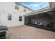 Inviting covered patio with outdoor furniture and brick pavers offers a relaxing outdoor living experience at 12024 Sonnet Ave, Orlando, FL 32832