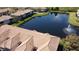 Scenic aerial view of community lake, fountains and building roofs at 1244 Romani Ave # 1244, Davenport, FL 33896