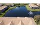 Aerial view of community pond, water fountain, and surrounding residences at 1244 Romani Ave # 1244, Davenport, FL 33896