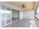 Screened balcony with tile flooring, ceiling fan, and sliding glass doors with a lake view at 1244 Romani Ave # 1244, Davenport, FL 33896