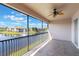 This large balcony with a ceiling fan has gorgeous views of the nearby lake at 1244 Romani Ave # 1244, Davenport, FL 33896