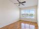 Bright bedroom with vaulted ceiling, fan, and large windows offering water view and ample natural light at 1244 Romani Ave # 1244, Davenport, FL 33896