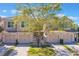 Street view of multiple townhomes with tan stucco, matching garage doors, and tile roofs at 1244 Romani Ave # 1244, Davenport, FL 33896