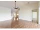 Open living space with hardwood floors and a ceiling fan at 1244 Romani Ave # 1244, Davenport, FL 33896