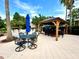 Outdoor kitchen area with a gazebo, bar seating, and dining tables under a bright blue sky at 1244 Romani Ave # 1244, Davenport, FL 33896