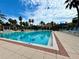 Resort-style pool with lounge chairs and umbrellas, surrounded by tropical landscaping at 1244 Romani Ave # 1244, Davenport, FL 33896