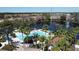 Aerial view of the pool and community area, showcasing the palm trees and lakeside setting at 1244 Romani Ave # 1244, Davenport, FL 33896