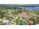 Expansive aerial view of homes near a lake with mature trees and luscious greenery at 12820 Butler Bay Ct, Windermere, FL 34786