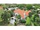 Aerial view of a house with a private pool and a red tile roof surrounded by lush landscaping at 12820 Butler Bay Ct, Windermere, FL 34786