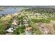 An aerial view showcases neighborhood with lush lawns and landscaping near a scenic lake at 12820 Butler Bay Ct, Windermere, FL 34786